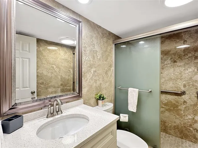 a bathroom with a sink toilet and shower