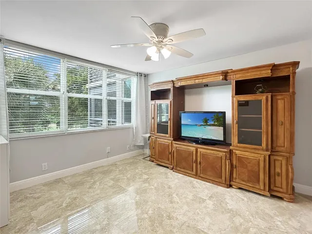 a living room with a flat screen tv and a large window