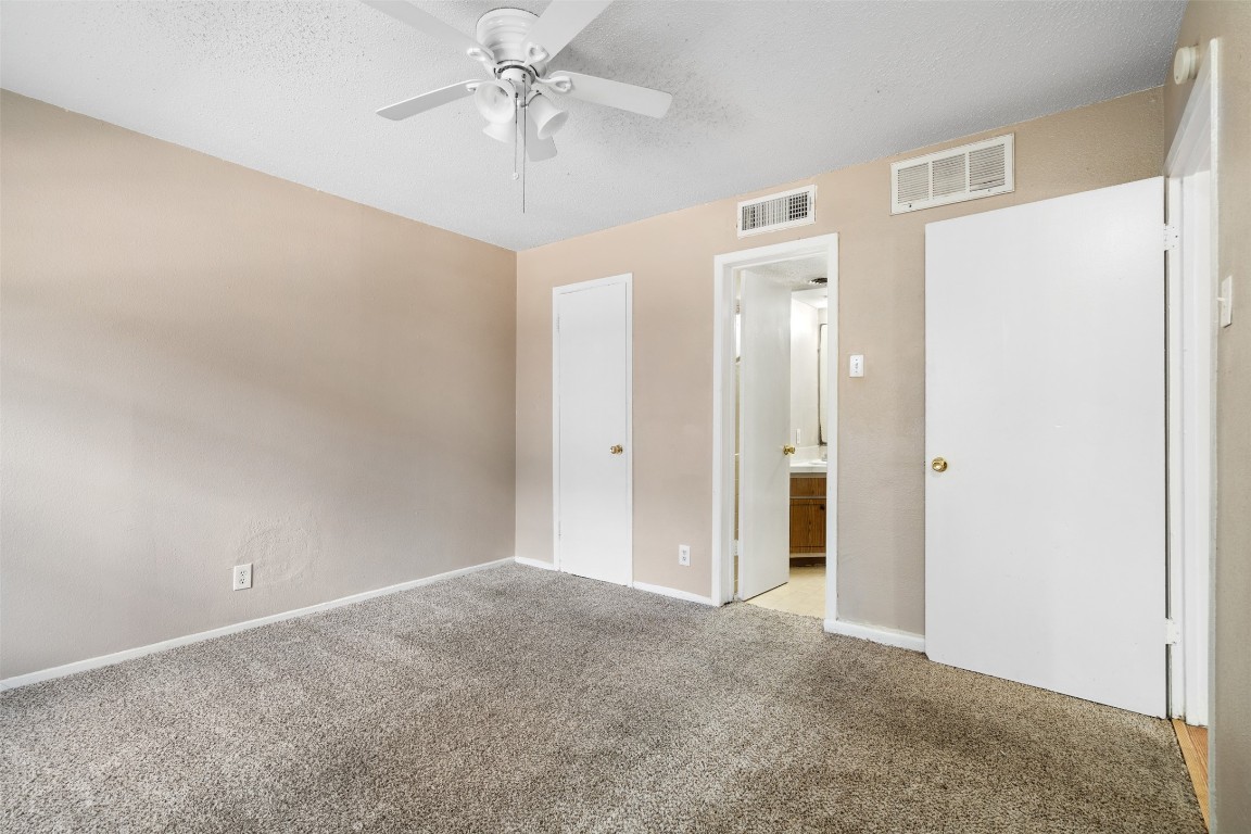 311 East 31st Street, Unit 107 Austin, TX 78705 - Photo 14 of 21 a view of a big room with chandelier fan and closet