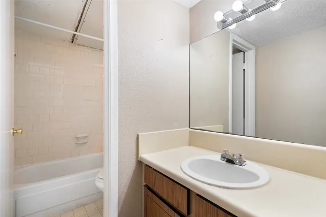 a bathroom with a bathtub and toilet