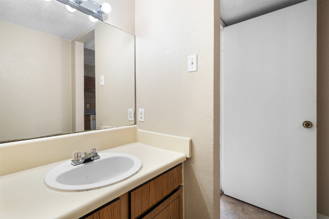 311 East 31st Street, Unit 107 Austin, TX 78705 - Photo 18 of 21 a bathroom with a sink and a mirror