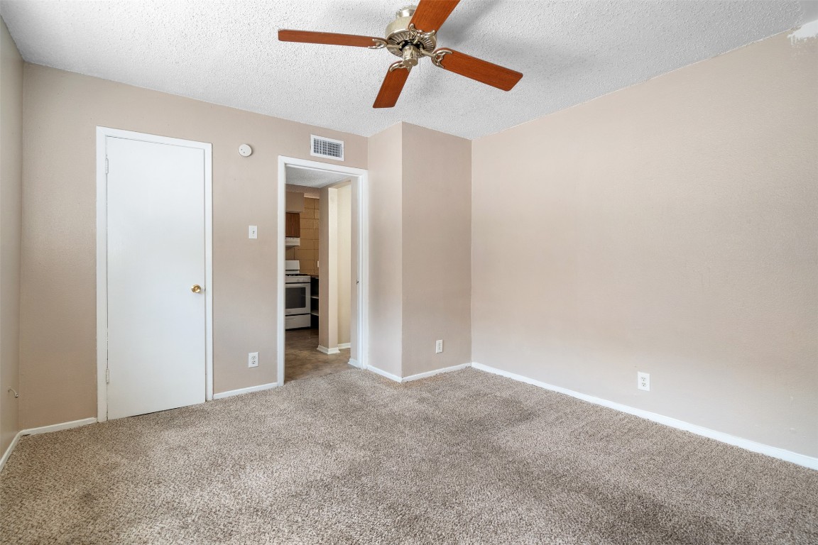 311 East 31st Street, Unit 107 Austin, TX 78705 - Photo 20 of 21 a view of a big room with closet and chandelier fan
