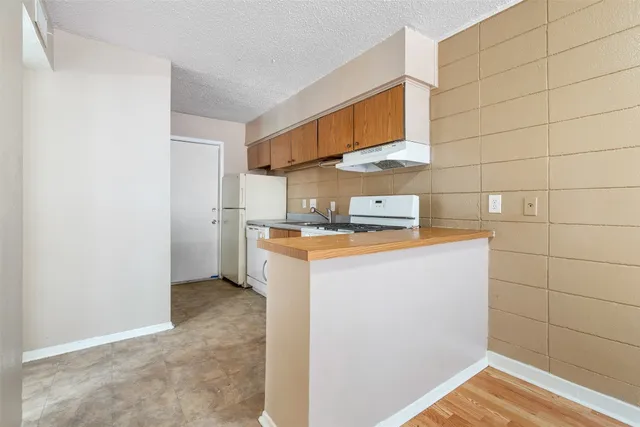 a kitchen with stainless steel appliances granite countertop a stove and a refrigerator