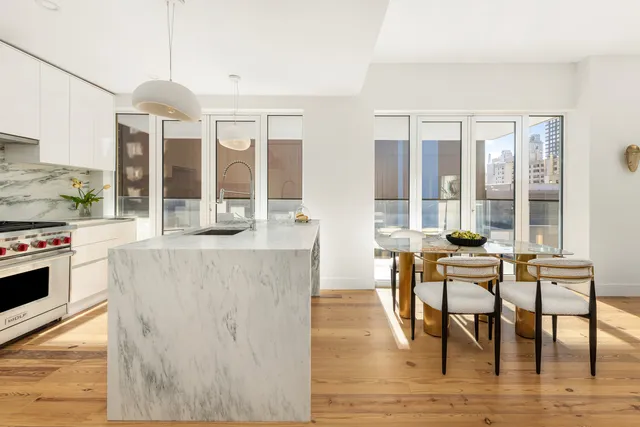 a kitchen with a table chairs stove and cabinets