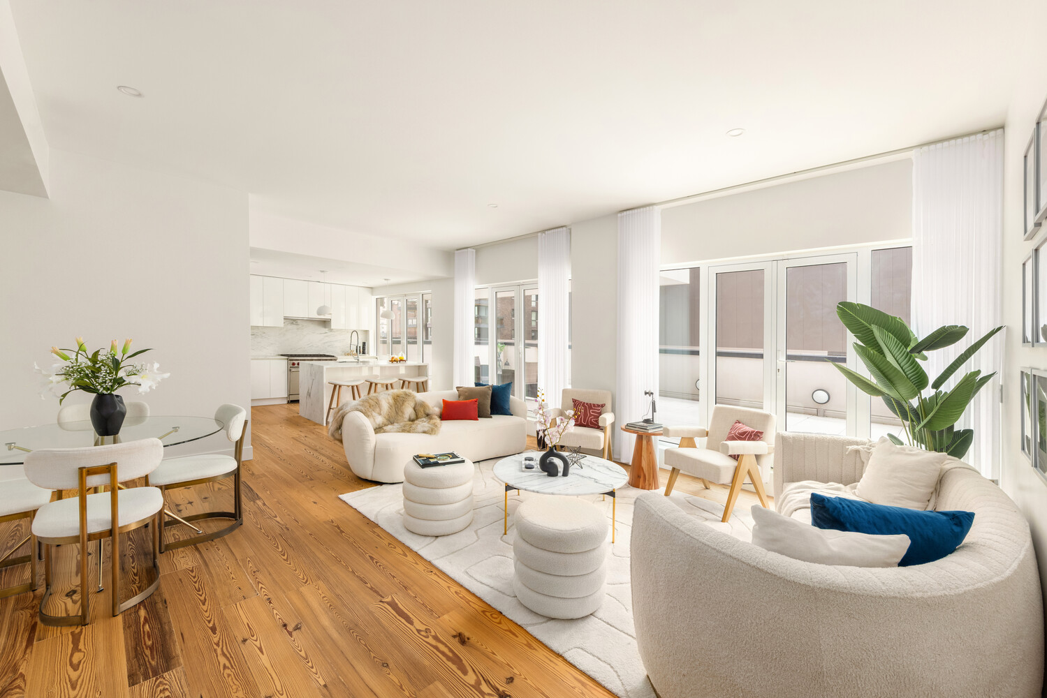 427 East 90th Street, Unit PH9/10 Manhattan, NY 10128 - Photo 8 of 27 a living room with furniture potted plant and a large mirror