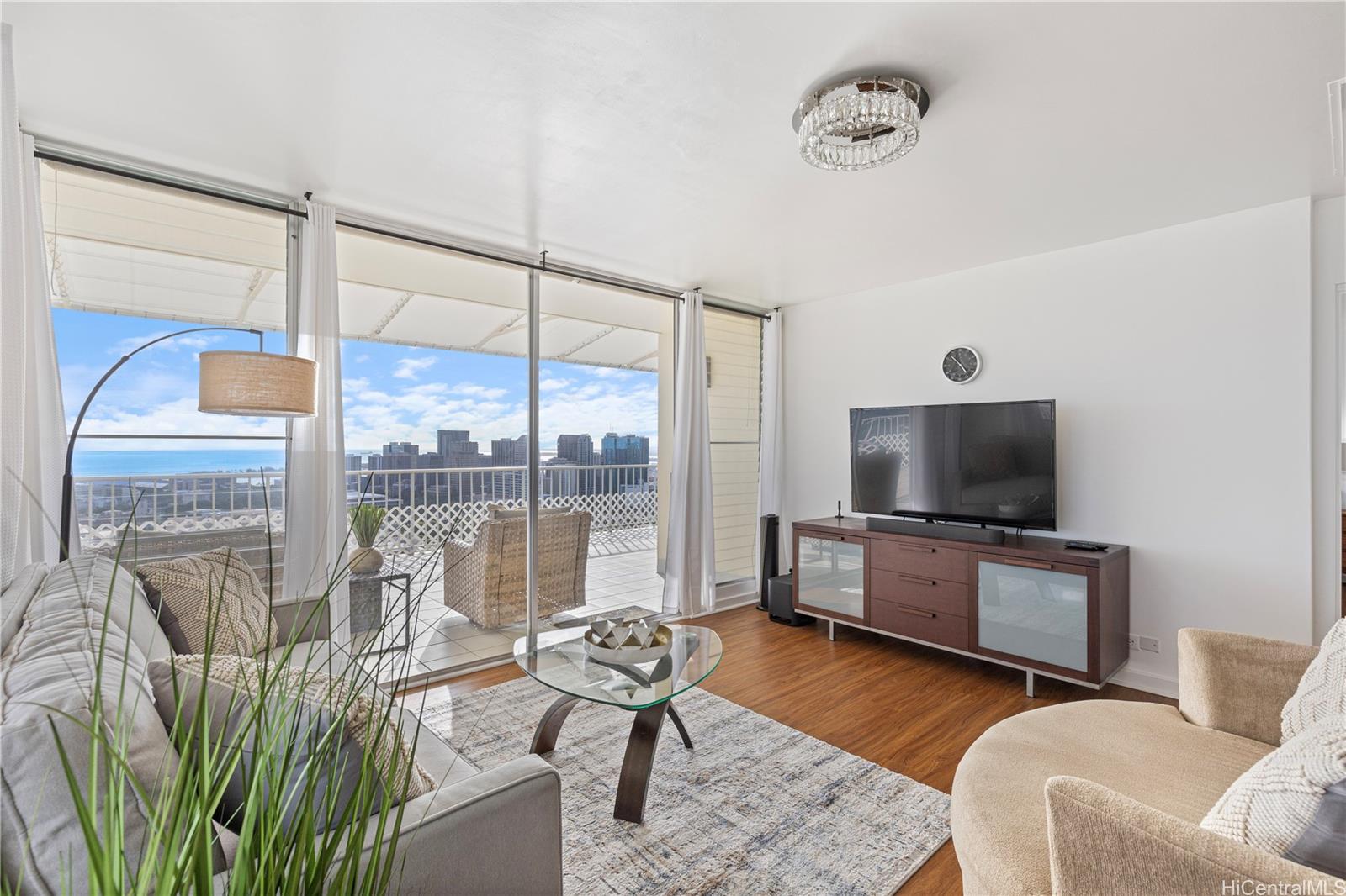 666 Prospect Street, Unit PH B Honolulu, HI 96813 - Photo 11 of 24 a living room with furniture a flat screen tv and a large window