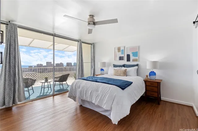 a bedroom with a bed and a large window