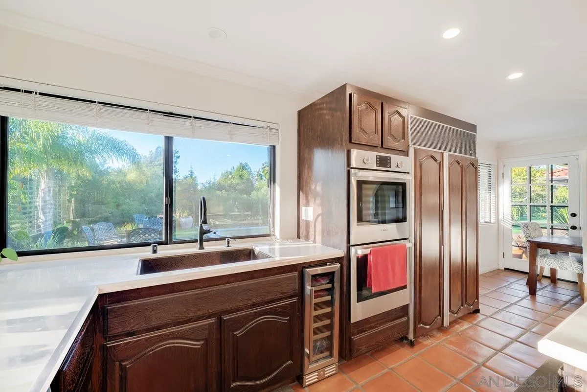 11 Country Glen Road Fallbrook, CA 92028 - Photo 14 of 75 a kitchen with stainless steel appliances granite countertop a refrigerator and a sink