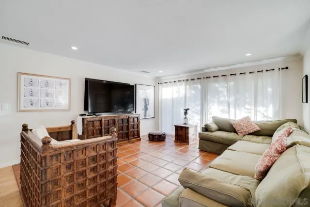 a view of a house with backyard sitting area and furniture