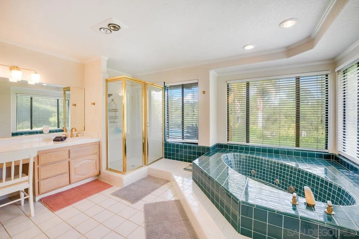 11 Country Glen Road Fallbrook, CA 92028 - Photo 25 of 75 a spacious bedroom with a large bed and a chandelier