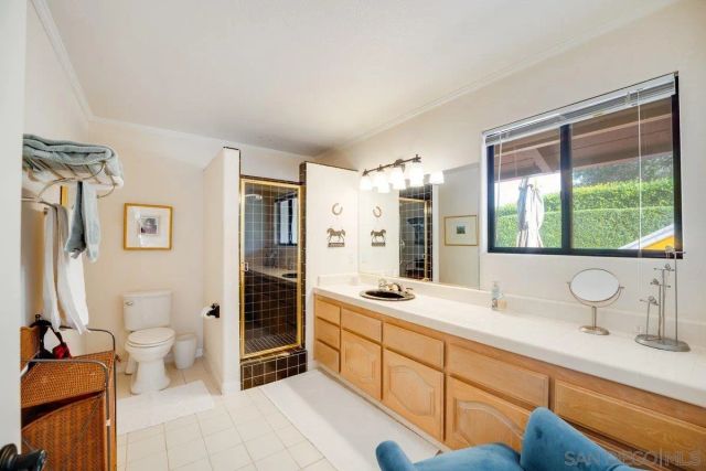 a bathroom with a sink and mirror with toilet