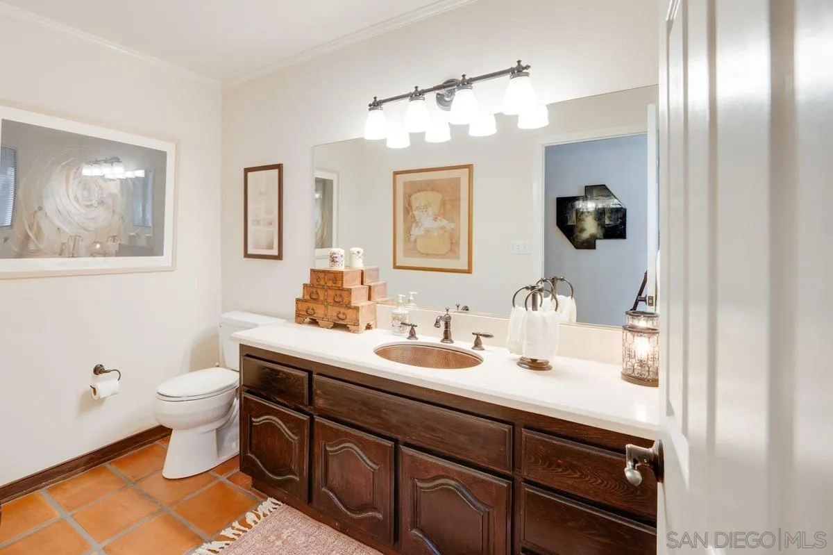 11 Country Glen Road Fallbrook, CA 92028 - Photo 30 of 75 a bathroom with a sink a toilet and mirror