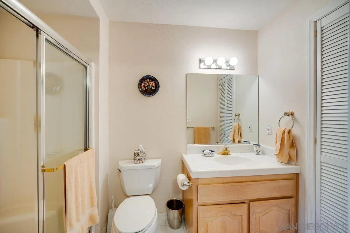 11 Country Glen Road Fallbrook, CA 92028 - Photo 35 of 75 a bathroom with a sink and mirror with toilet