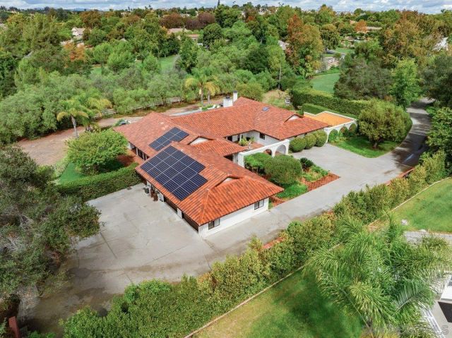 an aerial view of a house with a garden and yard
