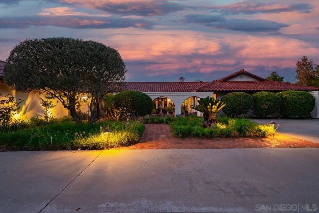a view of a street with a houses in the back