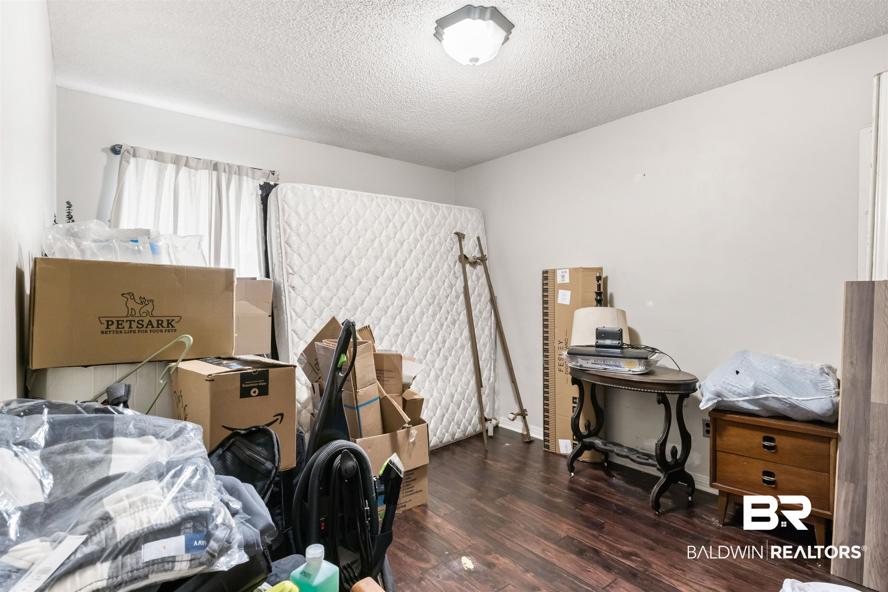 1345 Baker Court Mobile, AL 36695 - Photo 15 of 28 Bedroom featuring a textured ceiling and dark hardwood / wood-style floors
