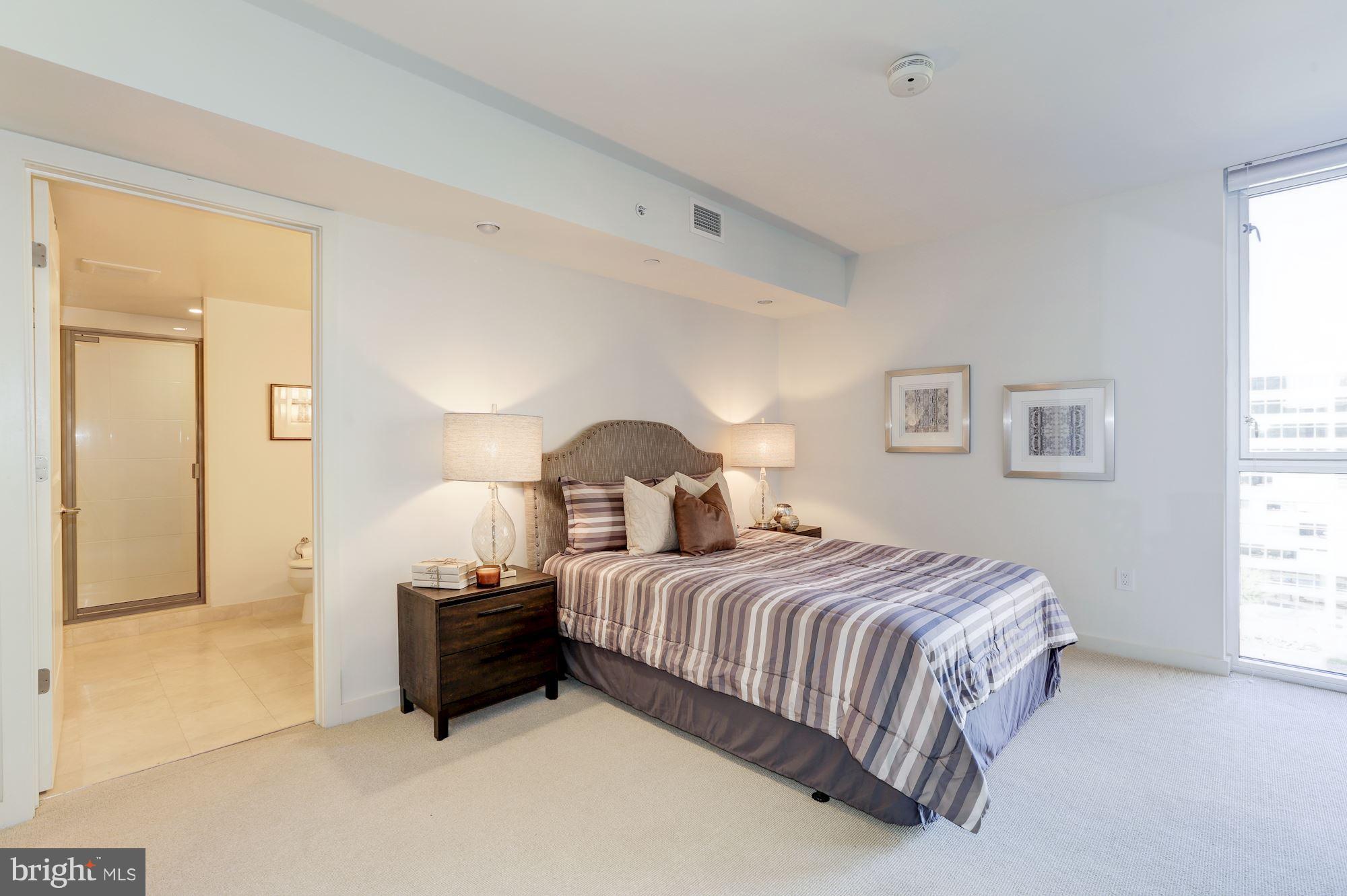 1025 First Street Southeast, Unit 916 Washington, DC 20003 - Photo 18 of 30 a bedroom with a bed and a lamp