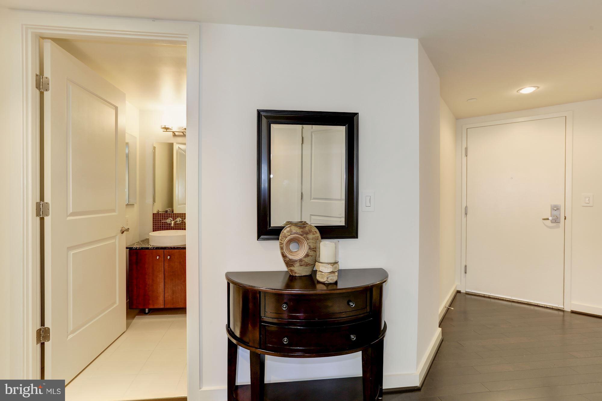 1025 First Street Southeast, Unit 916 Washington, DC 20003 - Photo 3 of 30 a room with furniture and wooden floor
