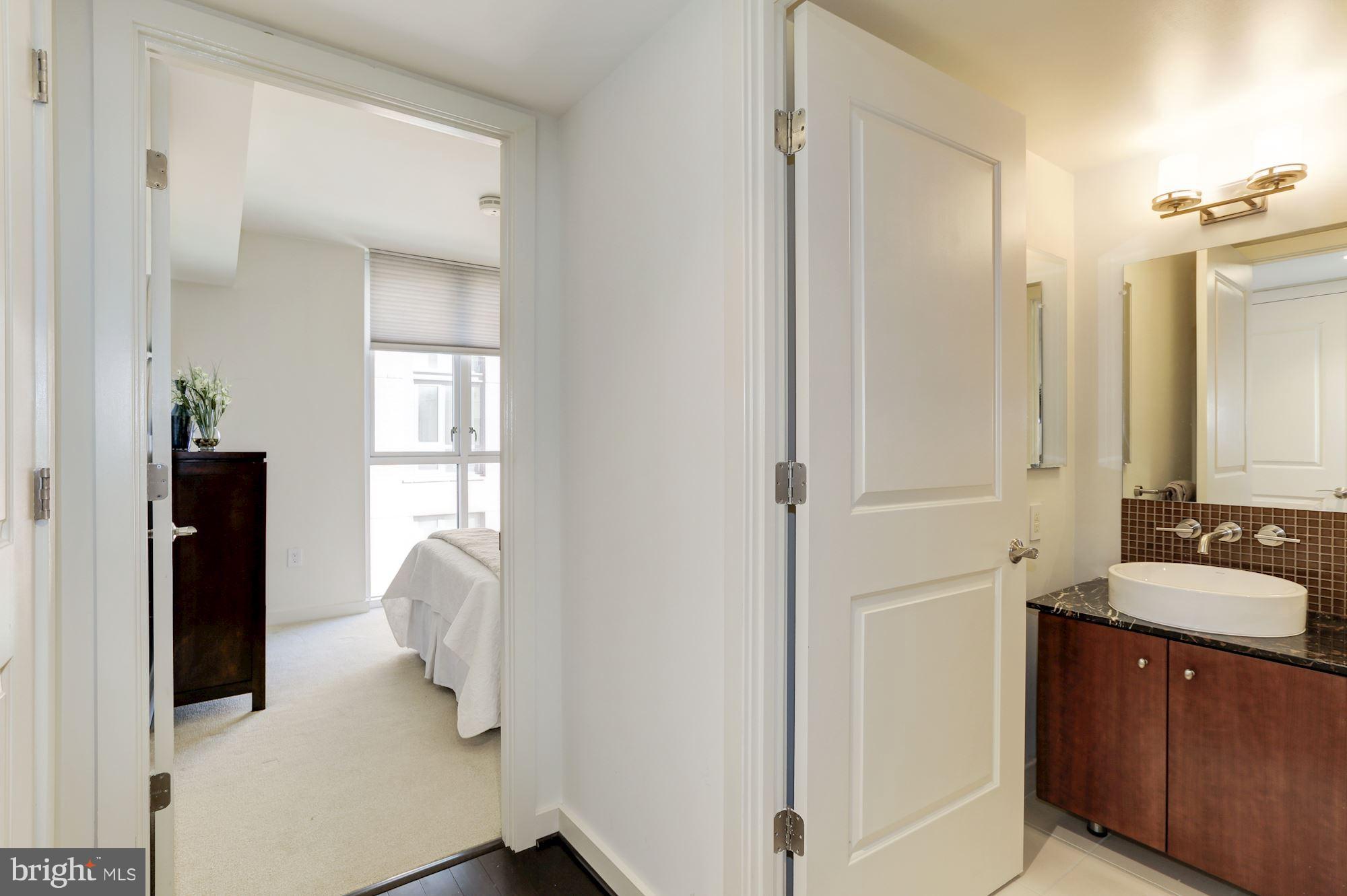 1025 First Street Southeast, Unit 916 Washington, DC 20003 - Photo 4 of 30 a bathroom with a sink and a mirror