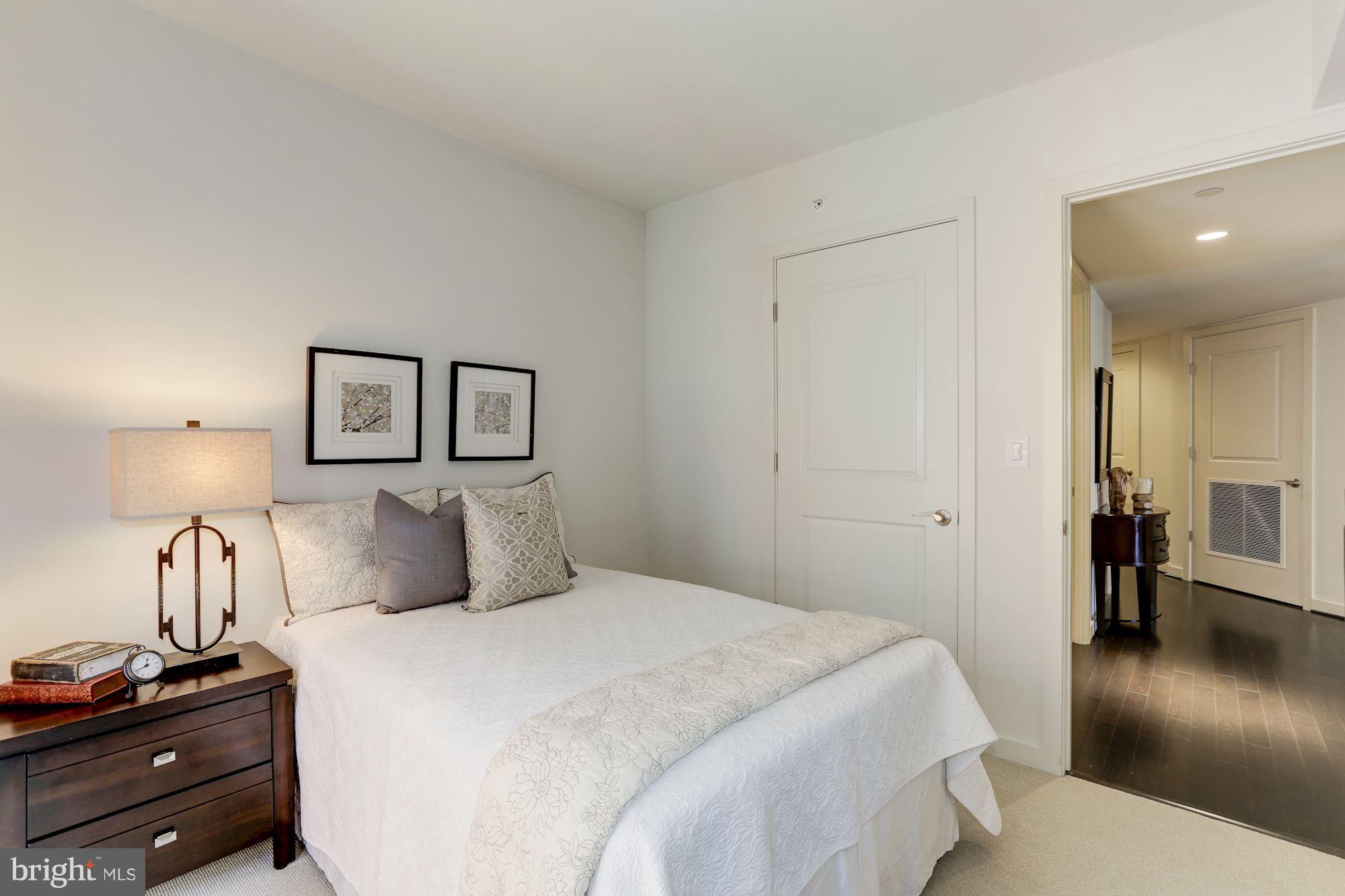 1025 First Street Southeast, Unit 916 Washington, DC 20003 - Photo 6 of 30 a bedroom with a bed and wooden floor