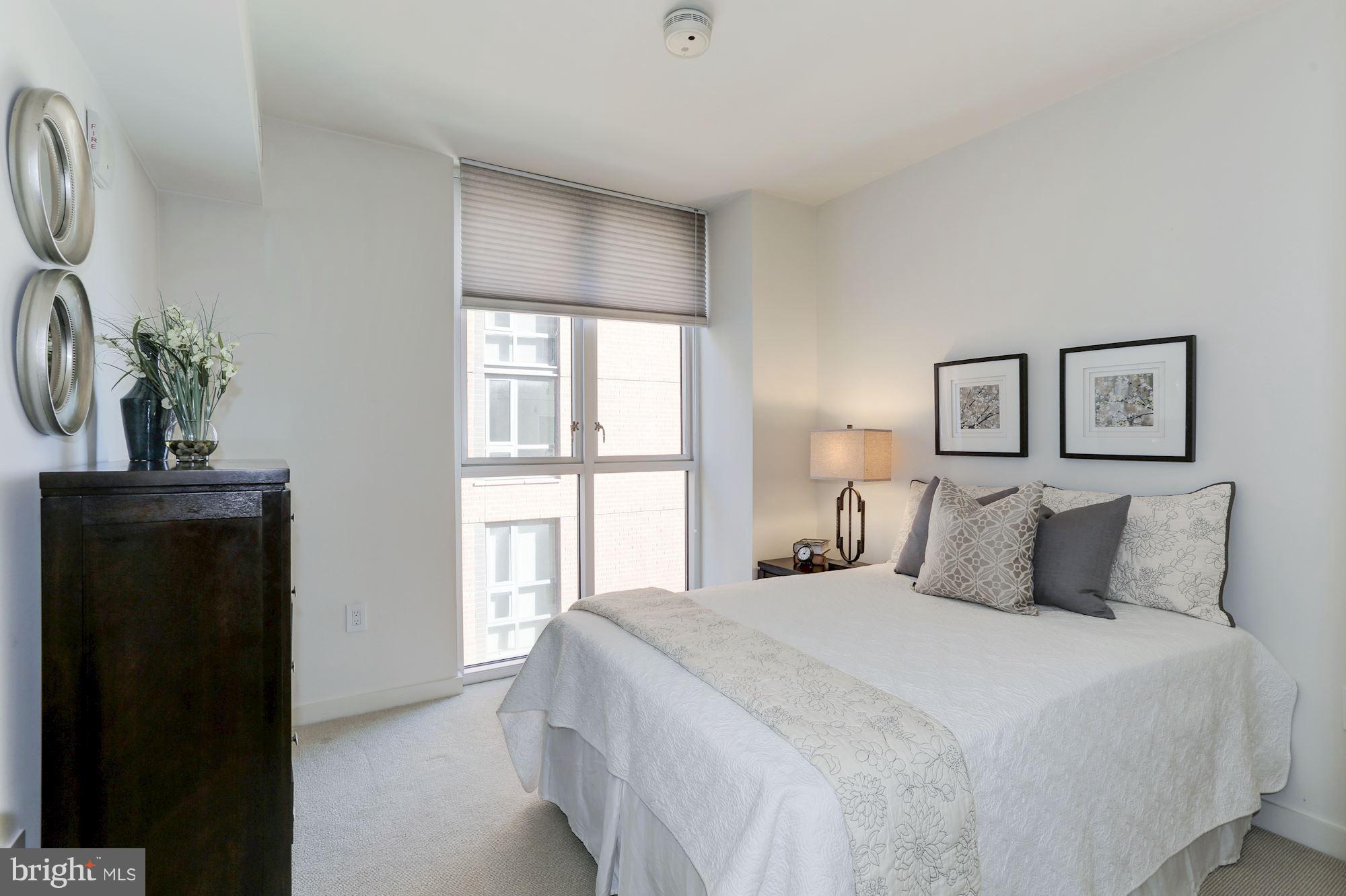 1025 First Street Southeast, Unit 916 Washington, DC 20003 - Photo 7 of 30 a bedroom with a large bed and a window