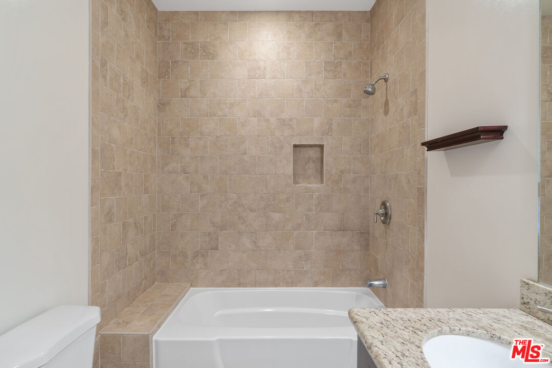 458 North Genesee Avenue Los Angeles, CA 90036 - Photo 19 of 38 a bathroom with a granite countertop bathtub shower and toilet