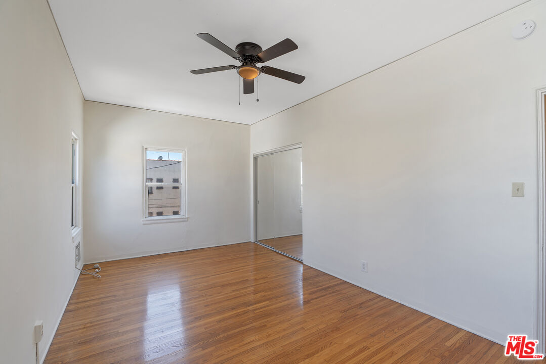 458 North Genesee Avenue Los Angeles, CA 90036 - Photo 22 of 38 an empty room with wooden floor and windows