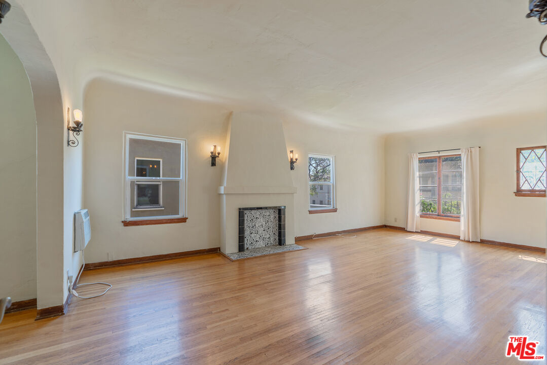 458 North Genesee Avenue Los Angeles, CA 90036 - Photo 3 of 38 a view of a livingroom with wooden floor and a fireplace