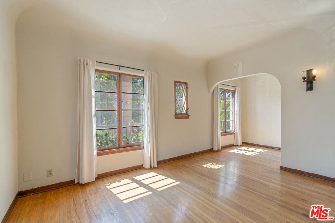 458 North Genesee Avenue Los Angeles, CA 90036 - Photo 8 of 38 an empty room with wooden floor and windows