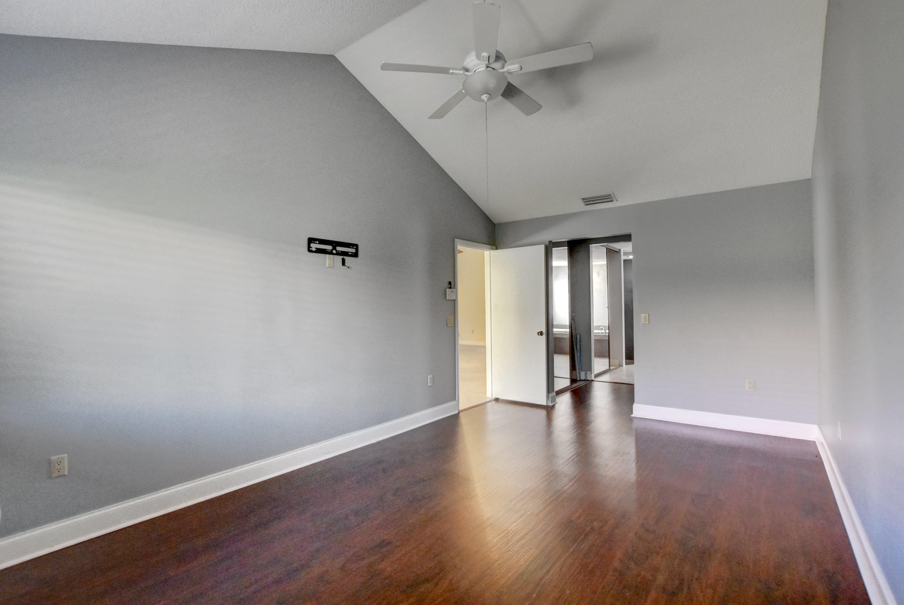 2602 Mohawk Circle West Palm Beach, FL 33409 - Photo 16 of 39 a view of an empty room with wooden floor and a window
