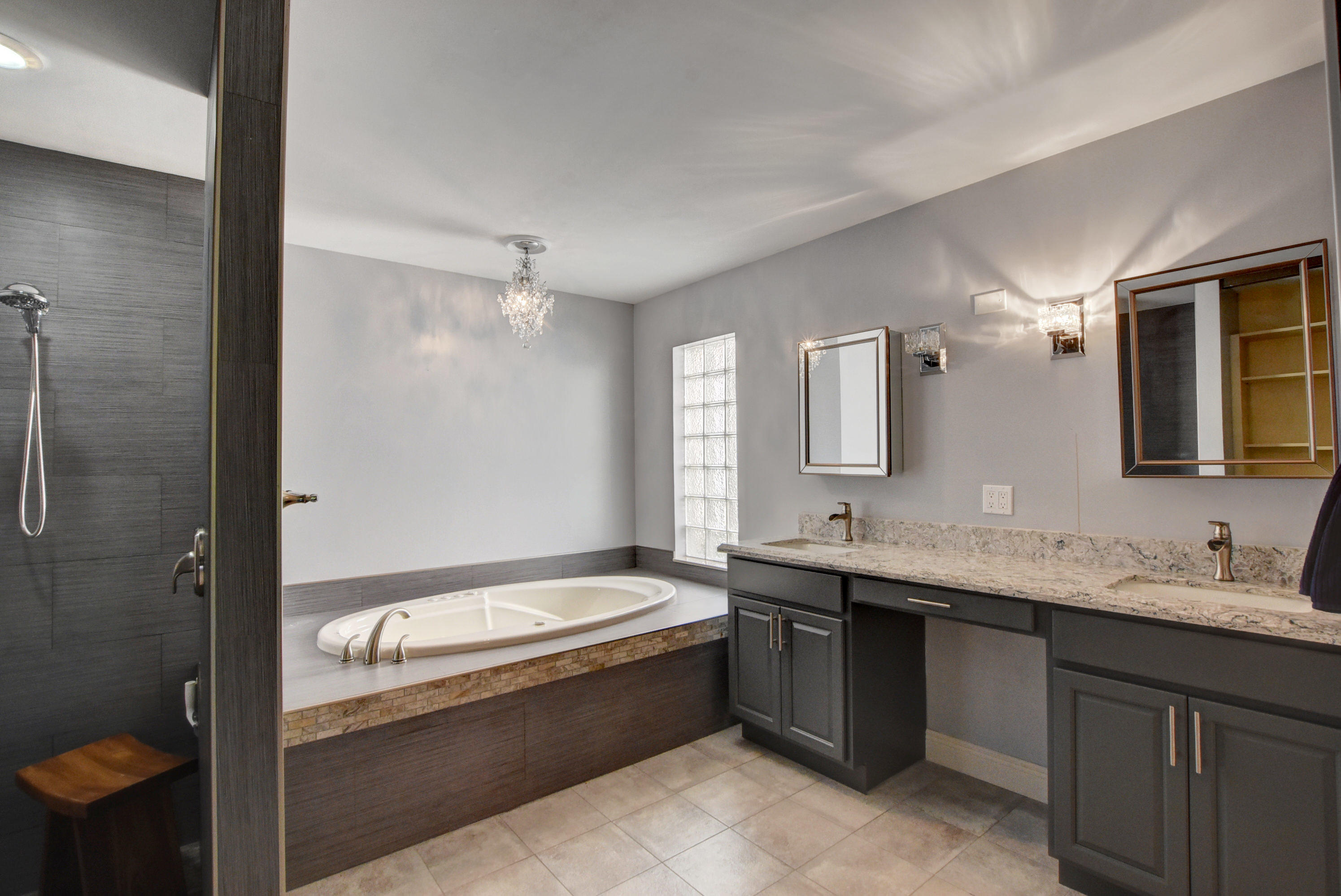 2602 Mohawk Circle West Palm Beach, FL 33409 - Photo 18 of 39 a bathroom with a granite countertop sink mirror and bathtub