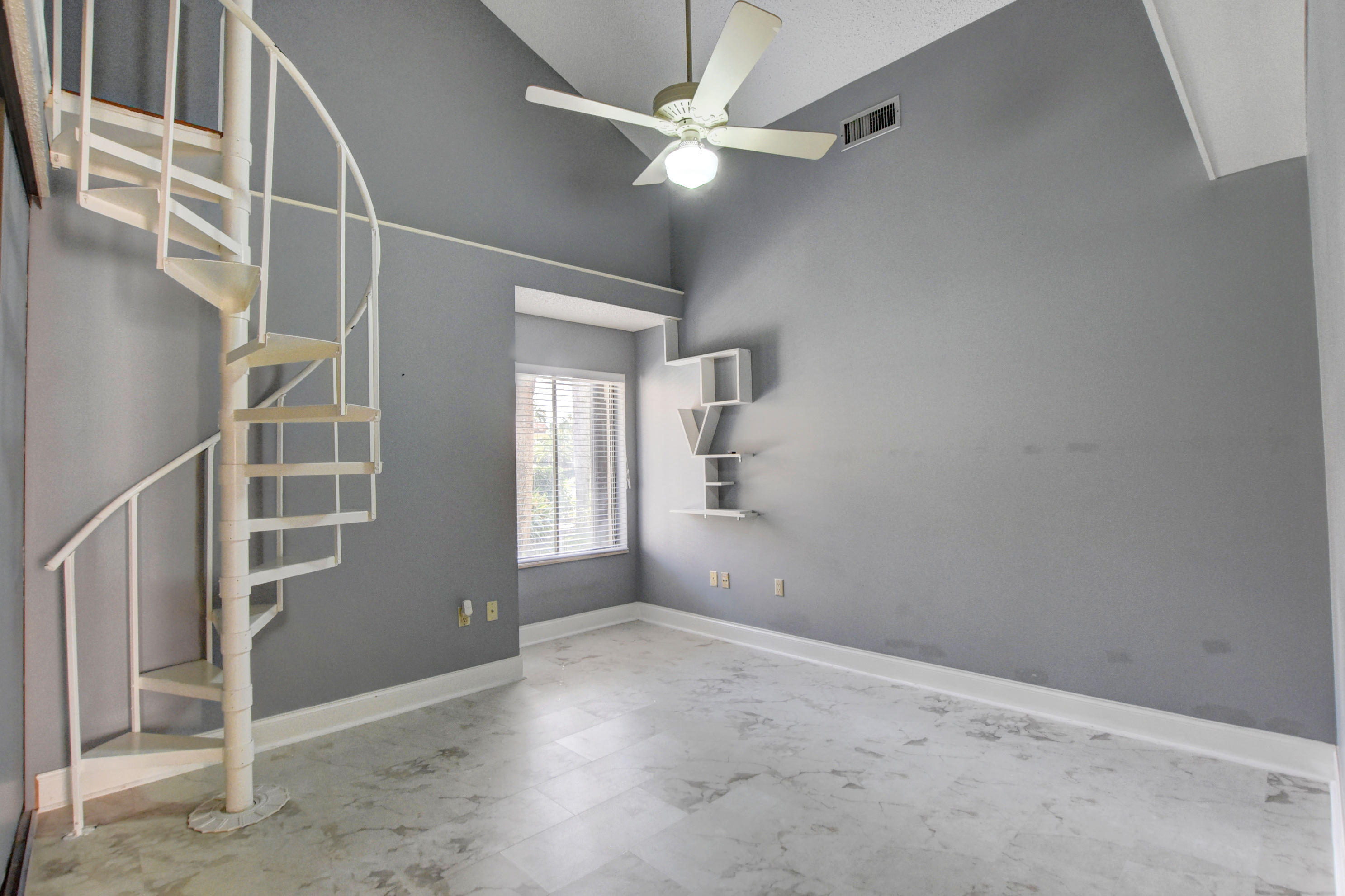 2602 Mohawk Circle West Palm Beach, FL 33409 - Photo 21 of 39 an empty room with windows and fan