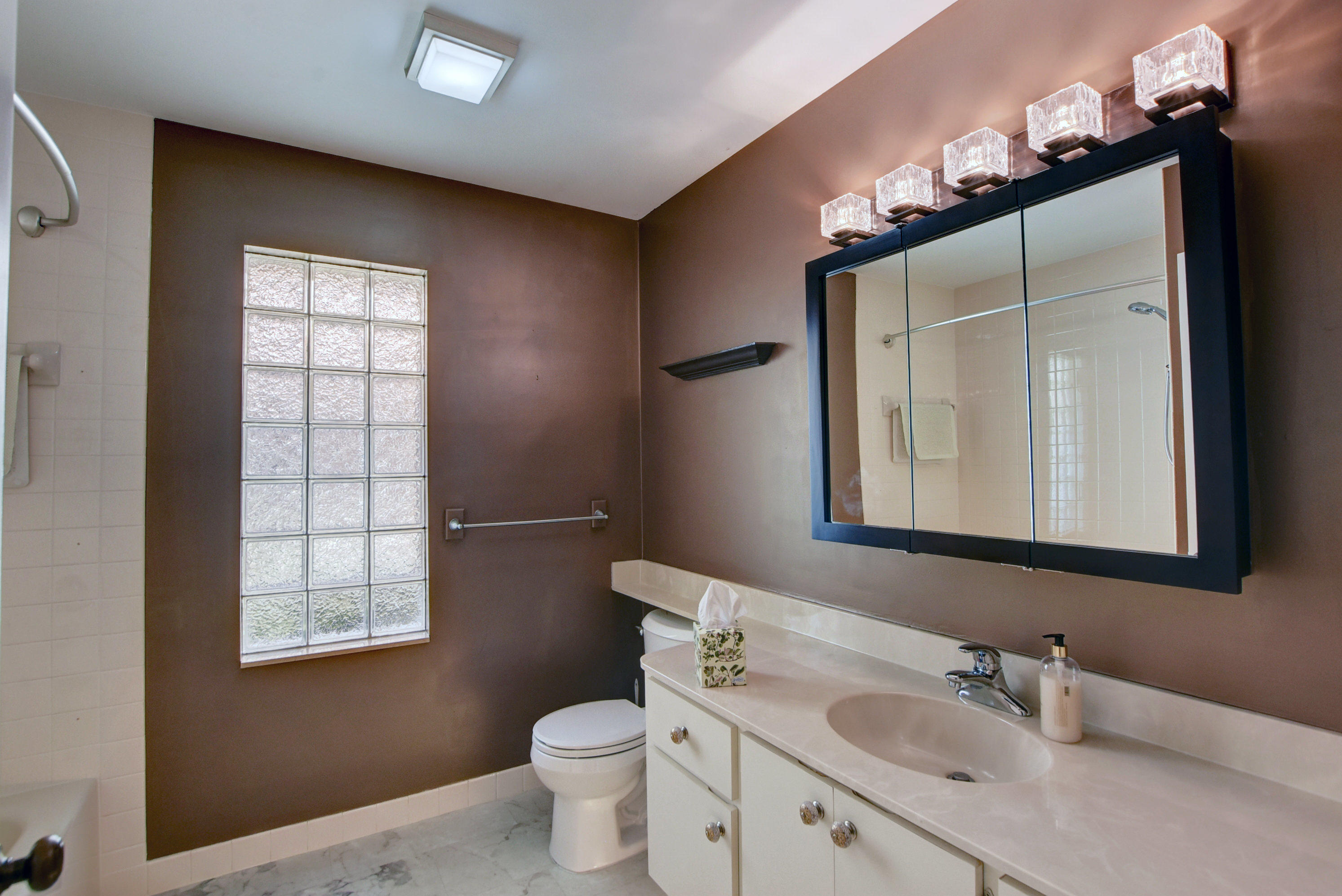 2602 Mohawk Circle West Palm Beach, FL 33409 - Photo 23 of 39 a bathroom with a toilet sink and mirror