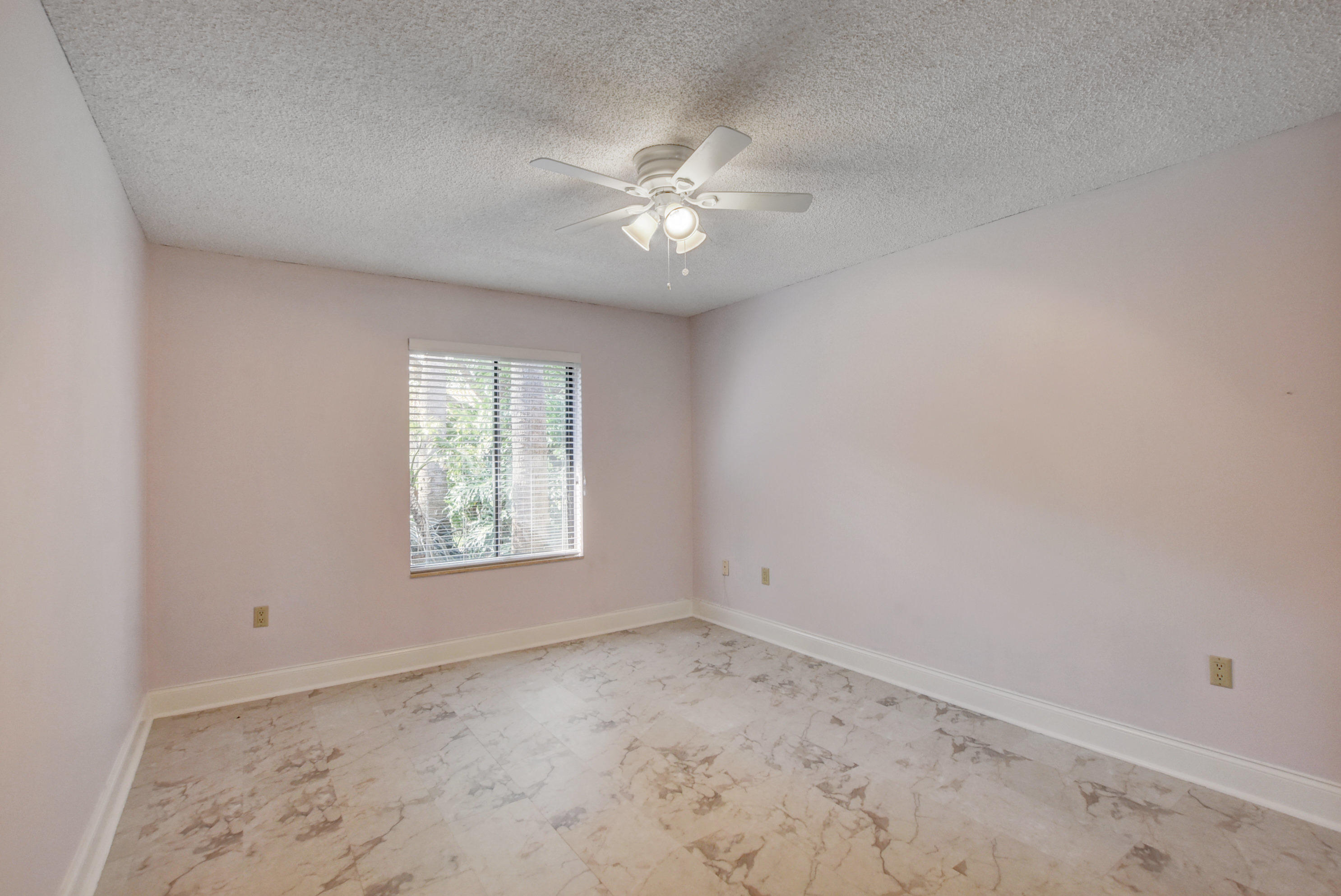2602 Mohawk Circle West Palm Beach, FL 33409 - Photo 24 of 39 an empty room with a window and a fan