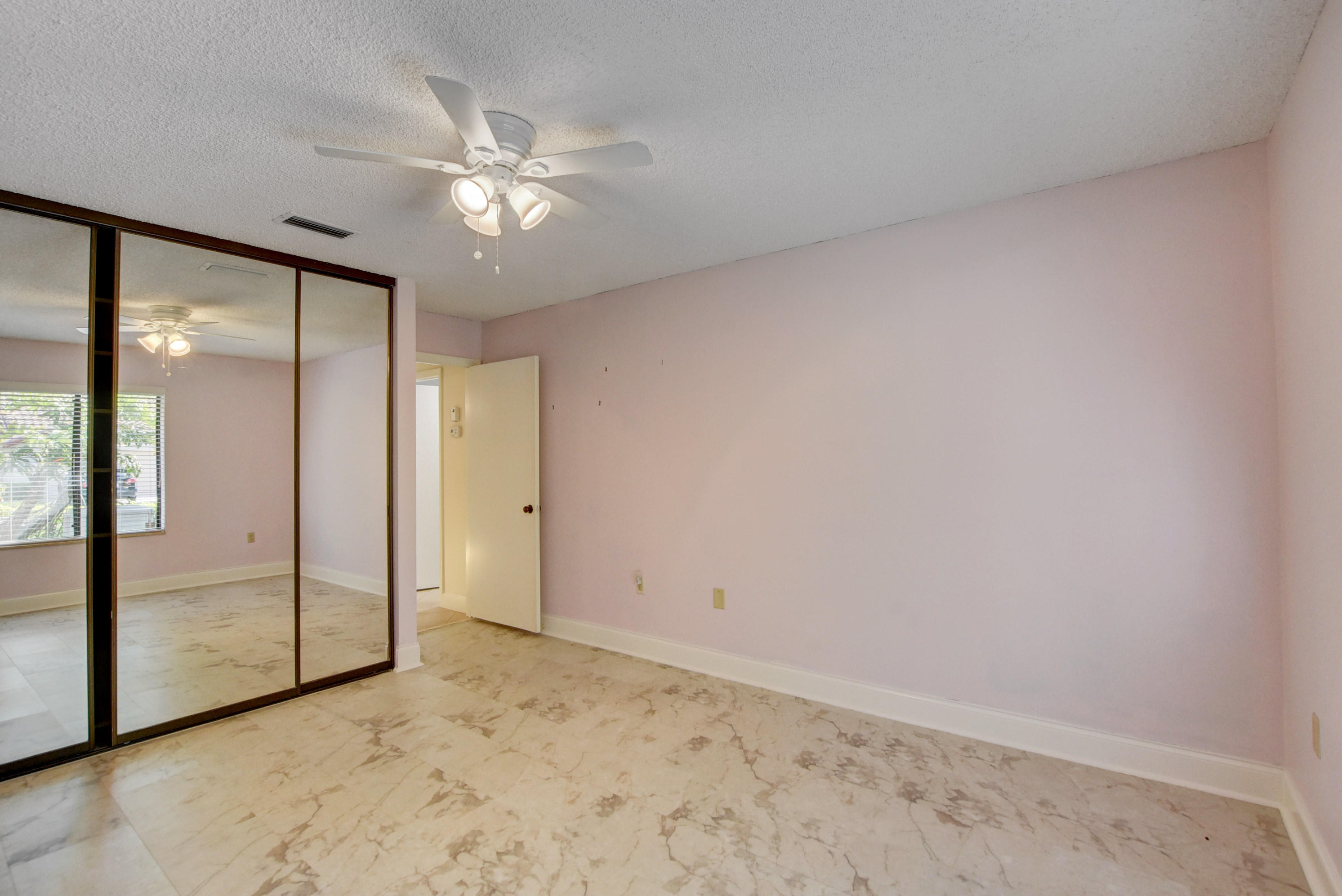 2602 Mohawk Circle West Palm Beach, FL 33409 - Photo 25 of 39 a view of a livingroom with a ceiling fan and window