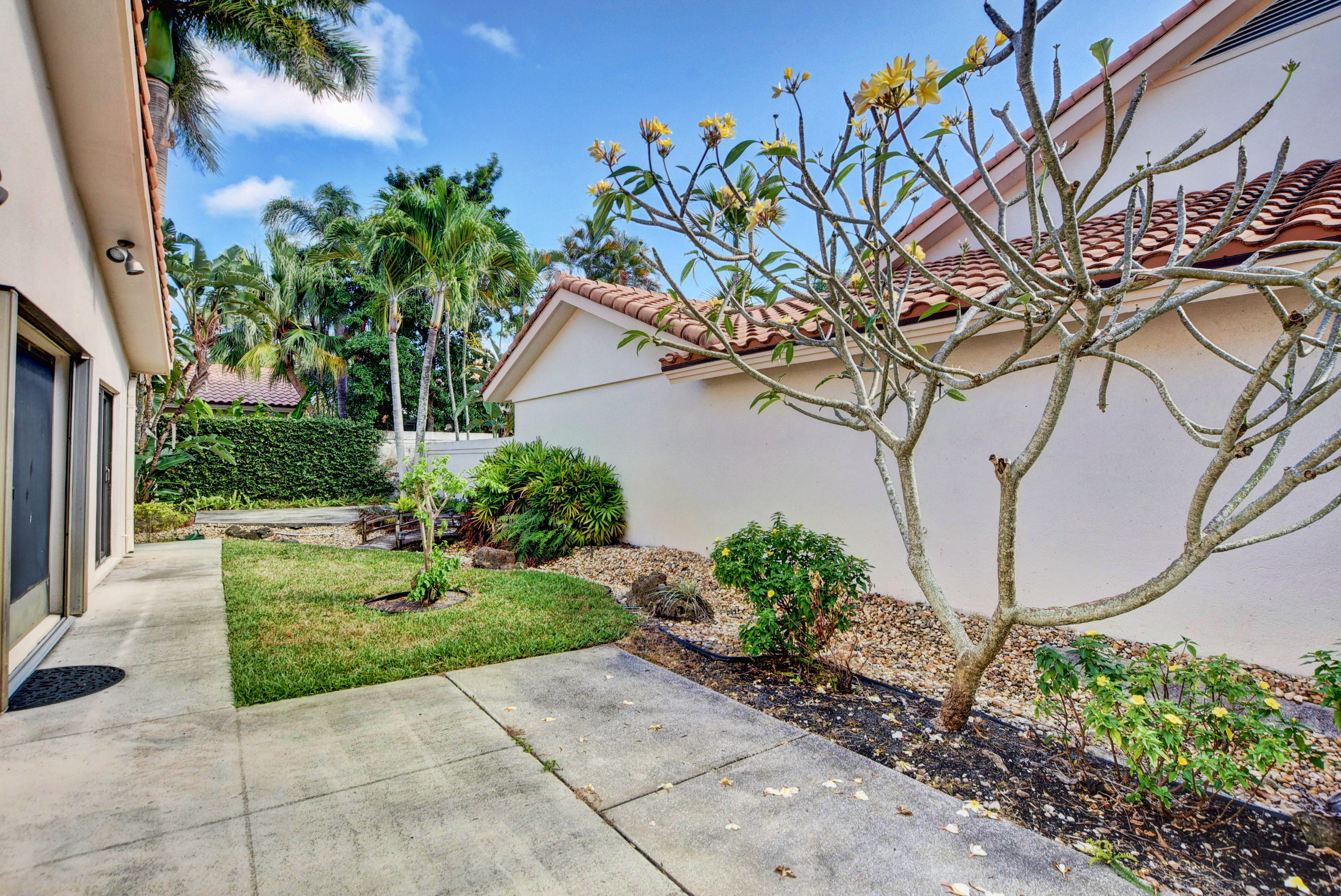 2602 Mohawk Circle West Palm Beach, FL 33409 - Photo 28 of 39 a view of backyard with plants and outdoor seating