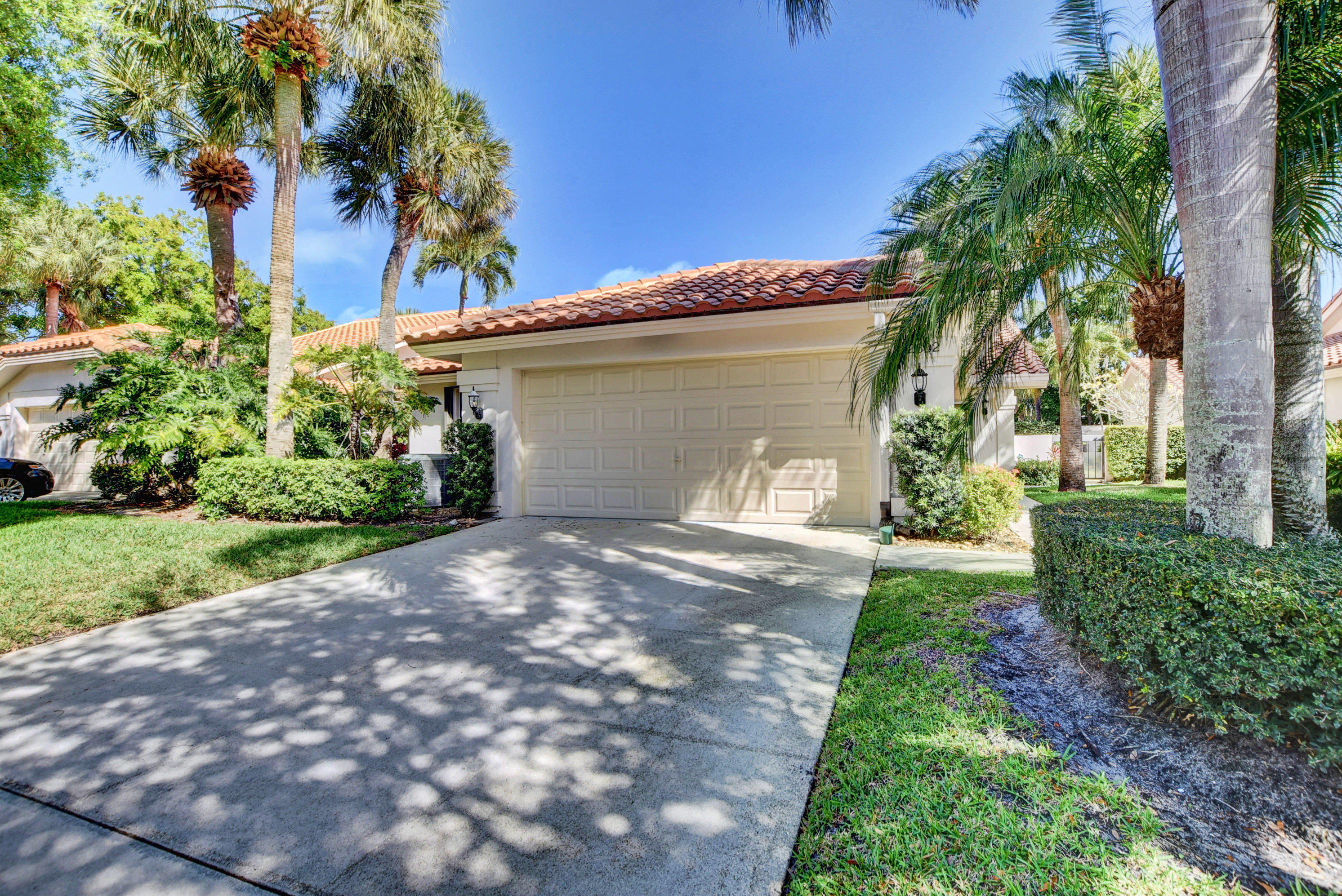 2602 Mohawk Circle West Palm Beach, FL 33409 - Photo 34 of 39 a front view of a house with garden
