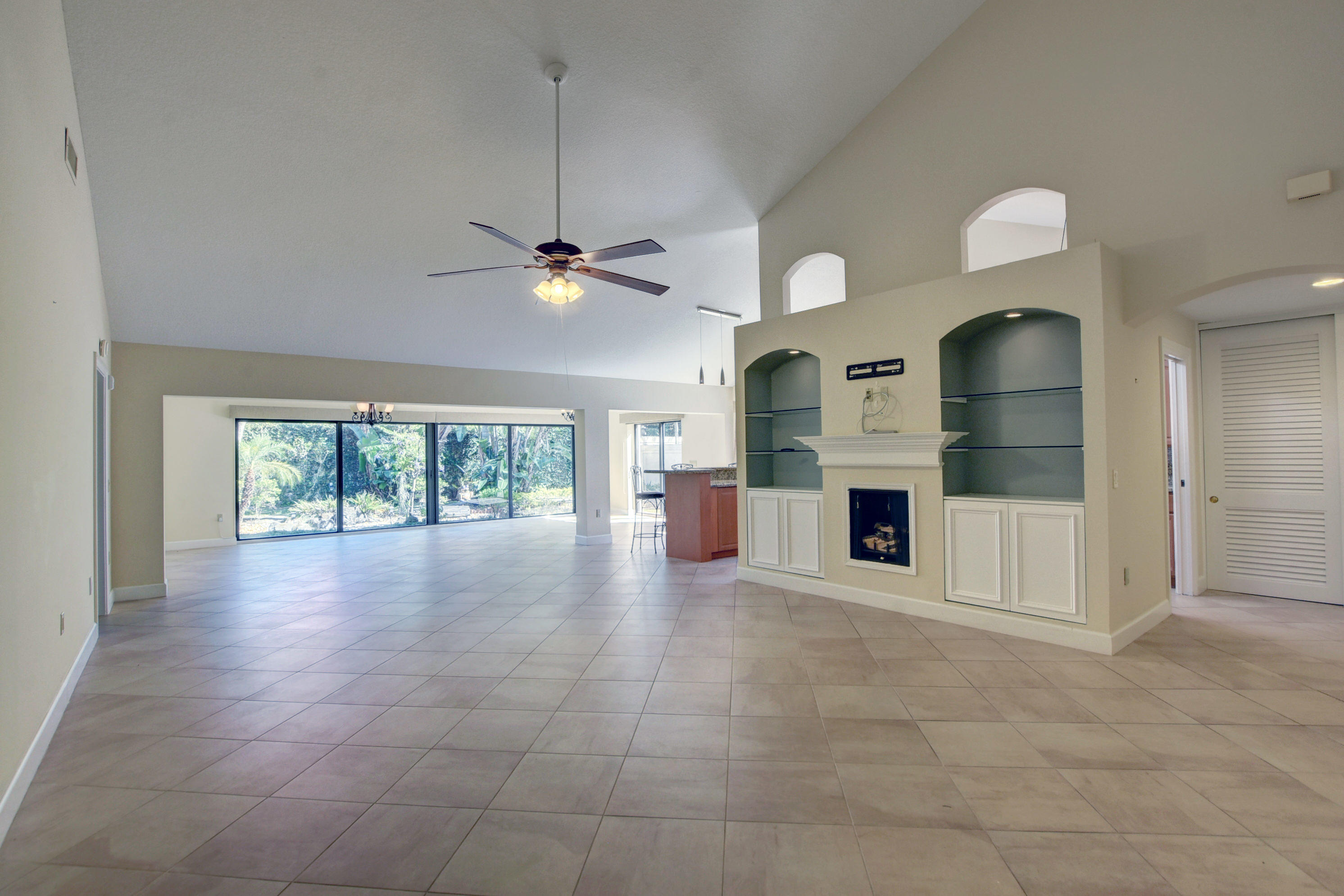 2602 Mohawk Circle West Palm Beach, FL 33409 - Photo 9 of 39 a view of an empty room with a fireplace and a window