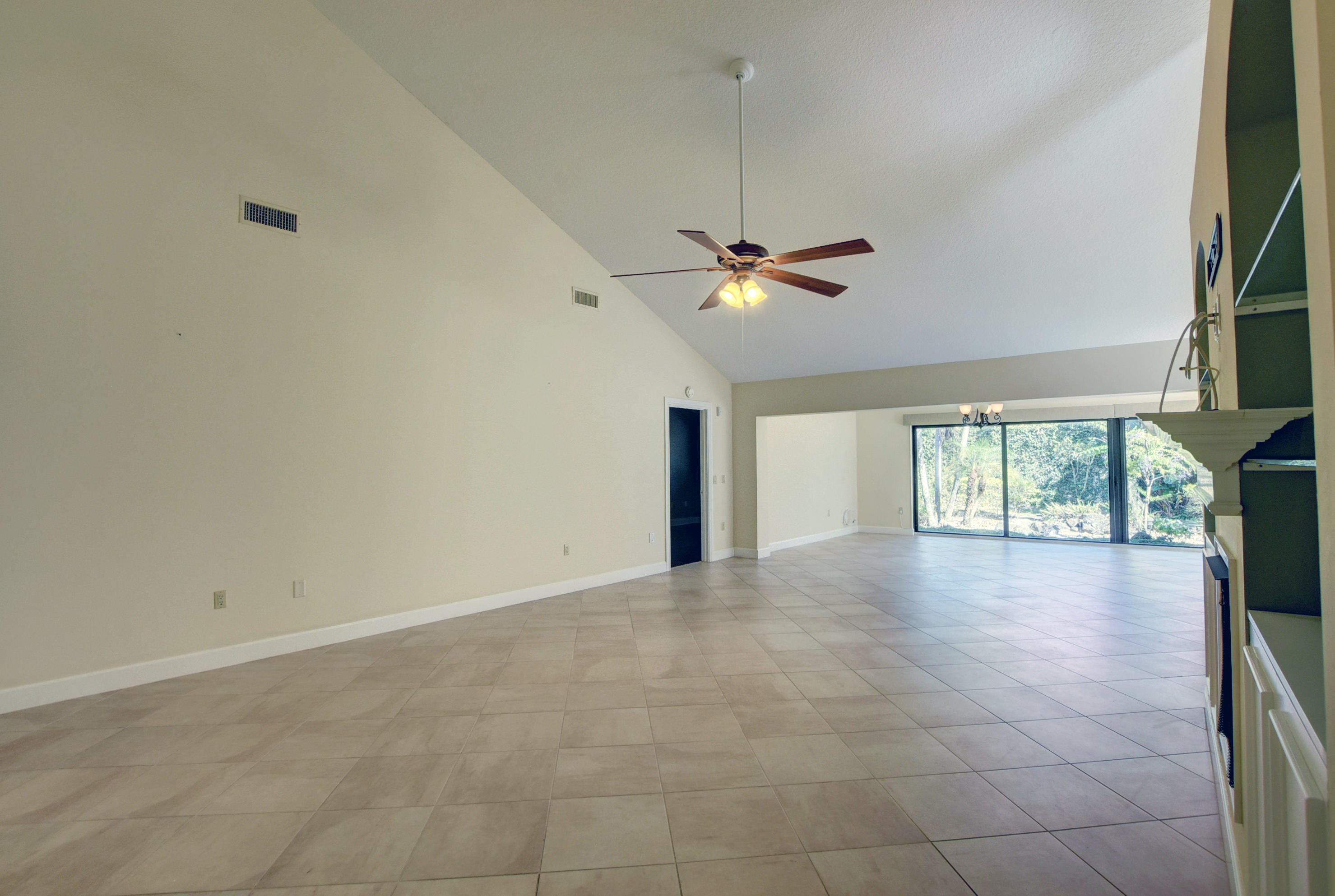 2602 Mohawk Circle West Palm Beach, FL 33409 - Photo 10 of 39 an empty room with windows and chandelier