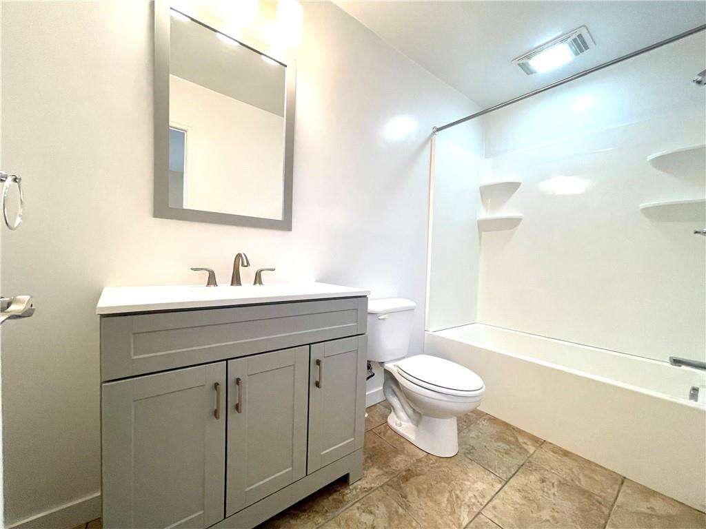 433 Augusta Street Pittsburgh, PA 15211 - Photo 17 of 21 a bathroom with a toilet sink and a mirror