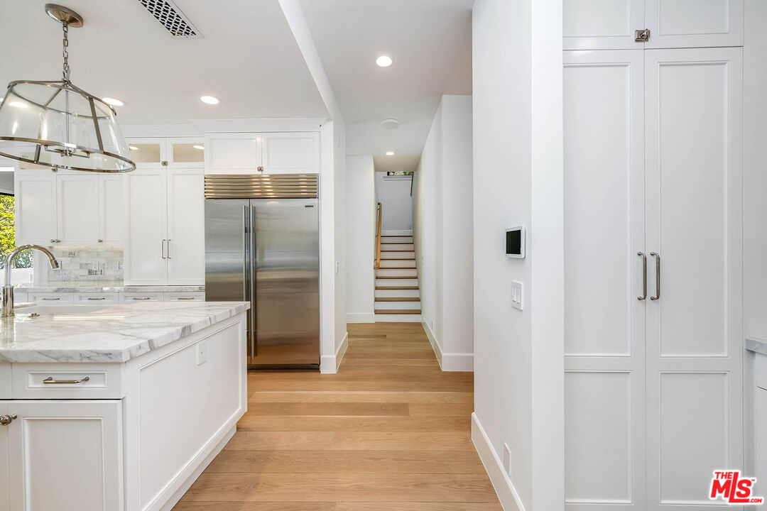 1348 Marinette Road Pacific Palisades, CA 90272 - Photo 12 of 50 a bathroom with a granite countertop sink a shower and a mirror
