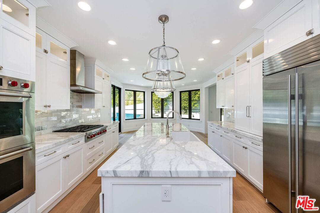 1348 Marinette Road Pacific Palisades, CA 90272 - Photo 13 of 50 a large kitchen with stainless steel appliances granite countertop a stove and a refrigerator