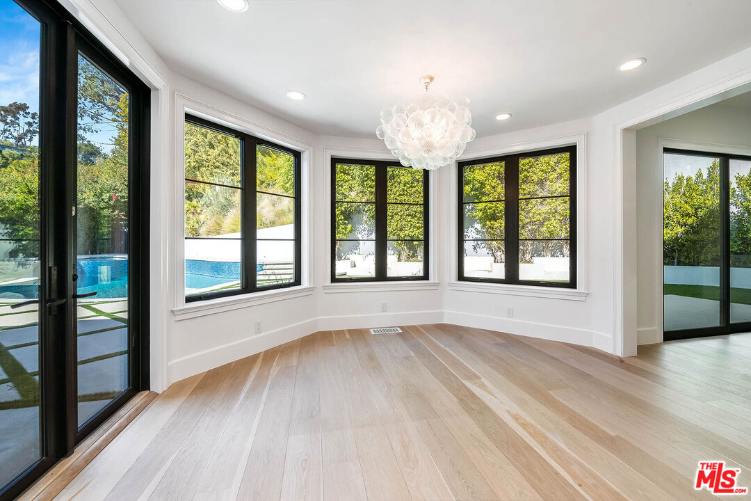 1348 Marinette Road Pacific Palisades, CA 90272 - Photo 14 of 50 a view of an empty room with wooden floor and a window