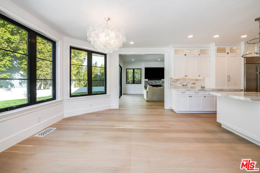 1348 Marinette Road Pacific Palisades, CA 90272 - Photo 16 of 50 a large white kitchen with large windows and refrigerator
