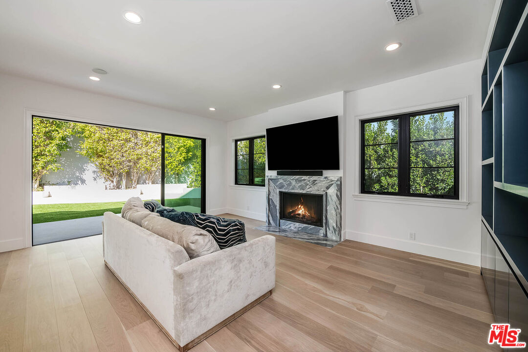 1348 Marinette Road Pacific Palisades, CA 90272 - Photo 18 of 50 a living room with furniture fireplace and flat screen tv