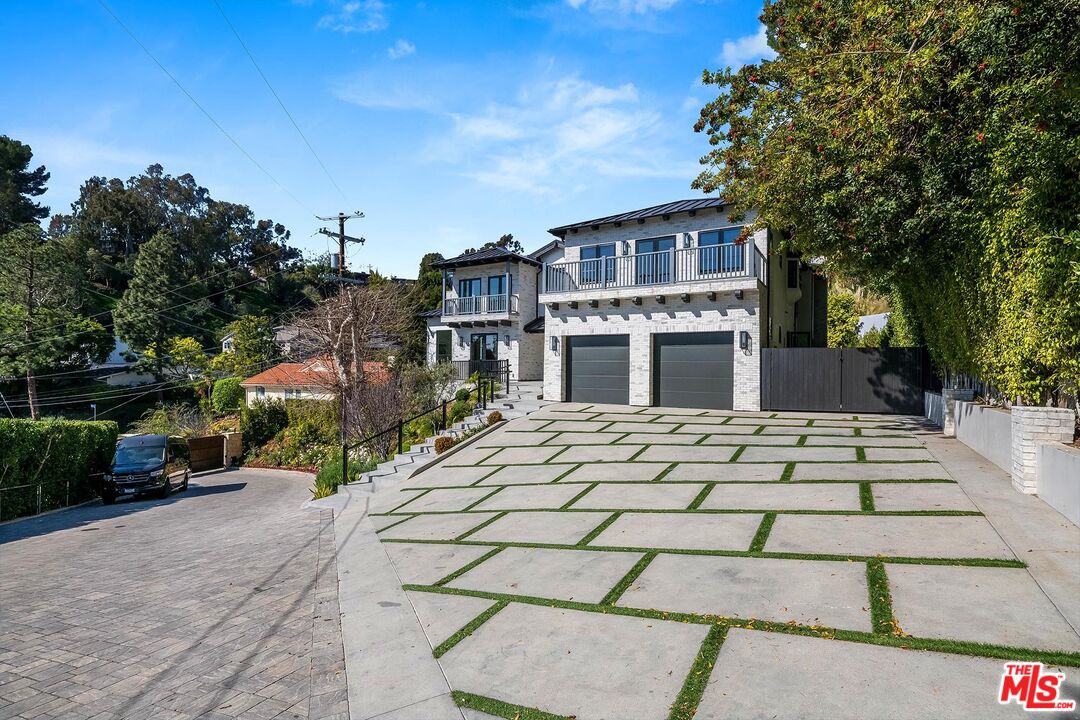 1348 Marinette Road Pacific Palisades, CA 90272 - Photo 2 of 50 a front view of a house with a yard