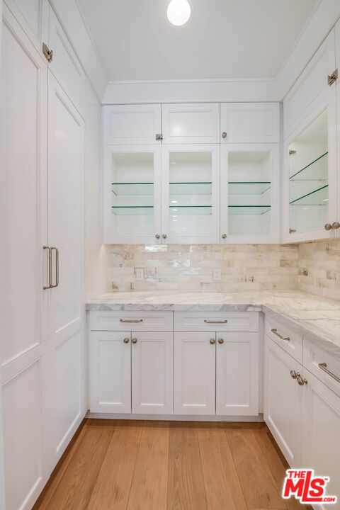 1348 Marinette Road Pacific Palisades, CA 90272 - Photo 26 of 50 a kitchen with granite countertop white cabinets and white appliances