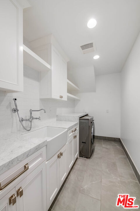 1348 Marinette Road Pacific Palisades, CA 90272 - Photo 27 of 50 a kitchen with a sink and cabinets