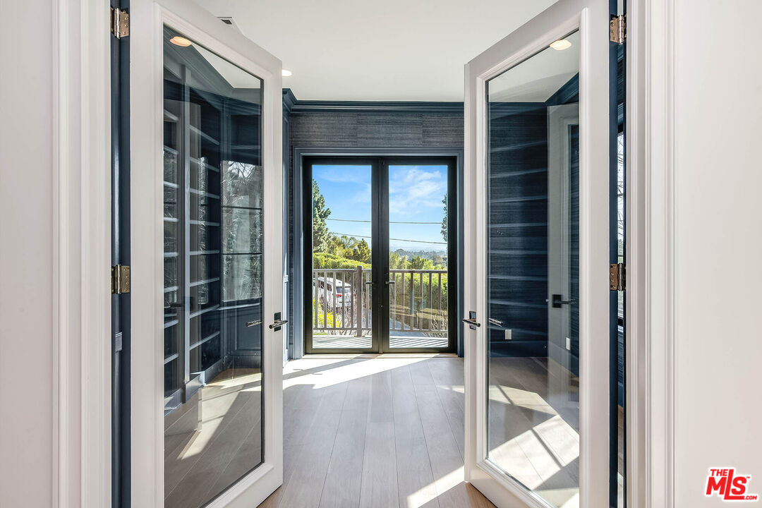 1348 Marinette Road Pacific Palisades, CA 90272 - Photo 30 of 50 a view of porch with a large window and wooden floor