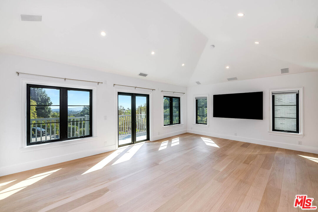 1348 Marinette Road Pacific Palisades, CA 90272 - Photo 33 of 50 a view of an empty room with a window and wooden floor